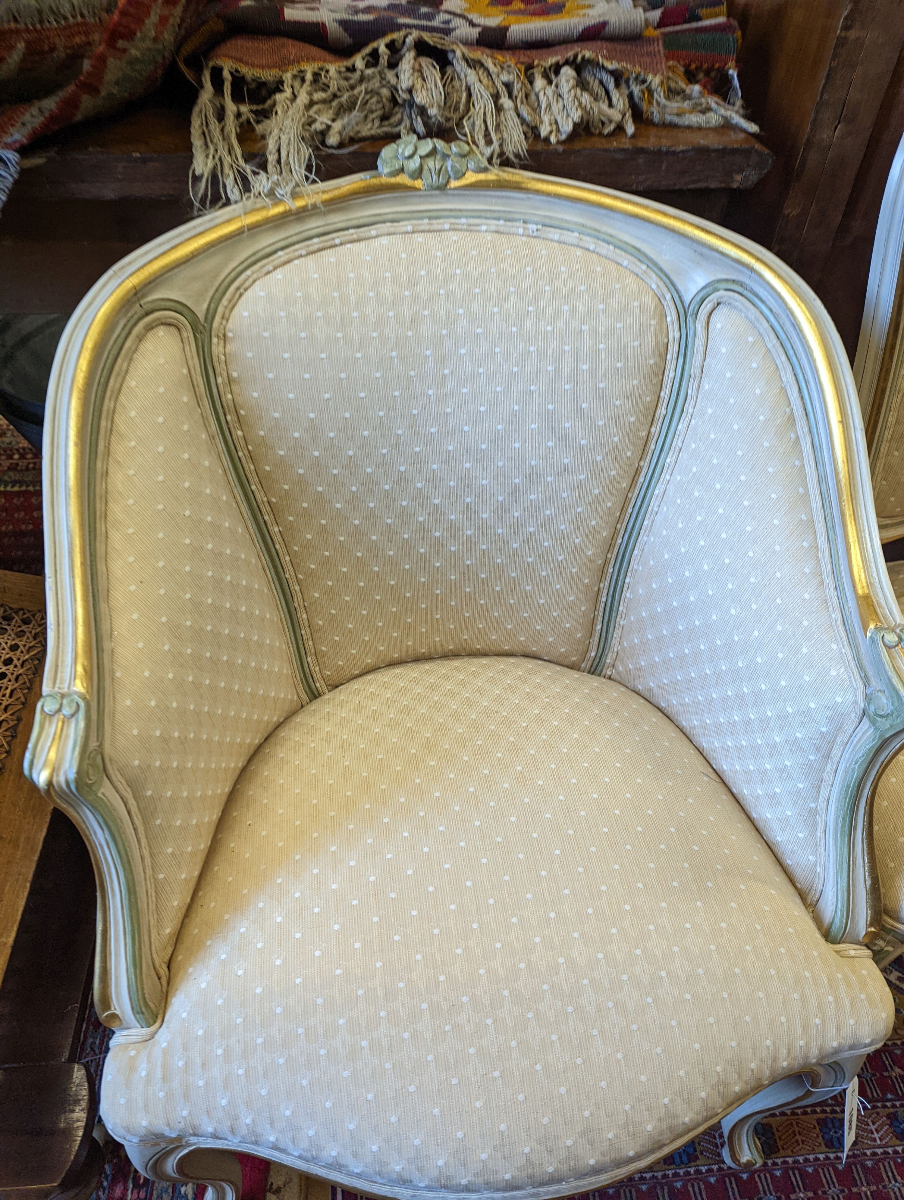A Louis XVI style painted upholstered tub chair and a similar side chair